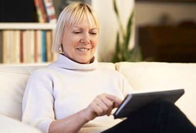 A woman reading on her tablet