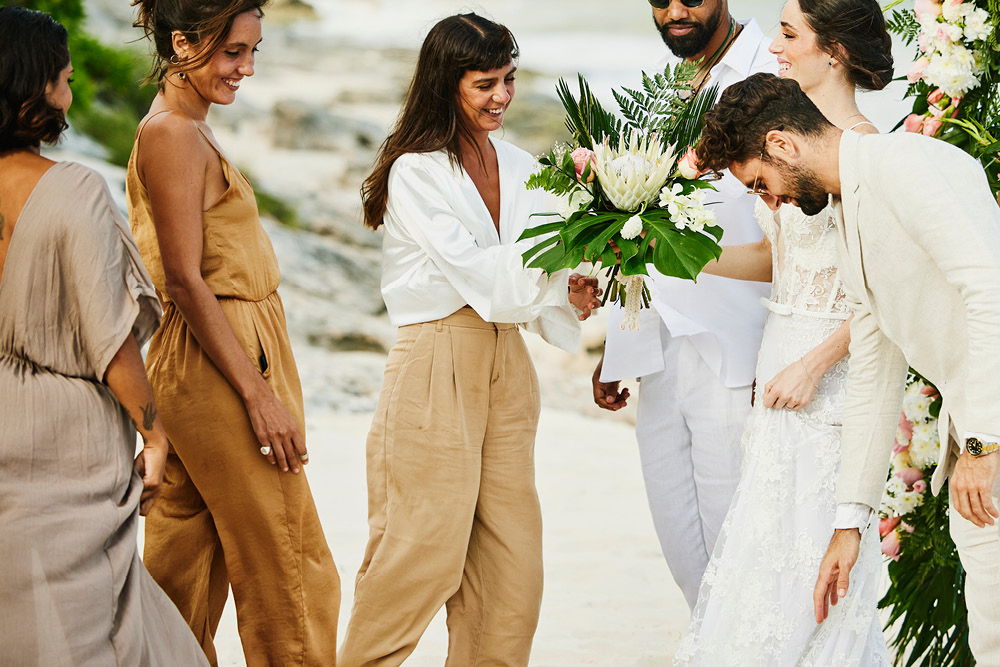 Destination wedding guests dressed in casual attire speaking with bride and groom