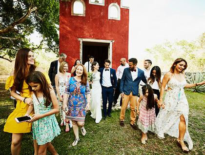 Bride, groom, and guests exiting venue at destination wedding