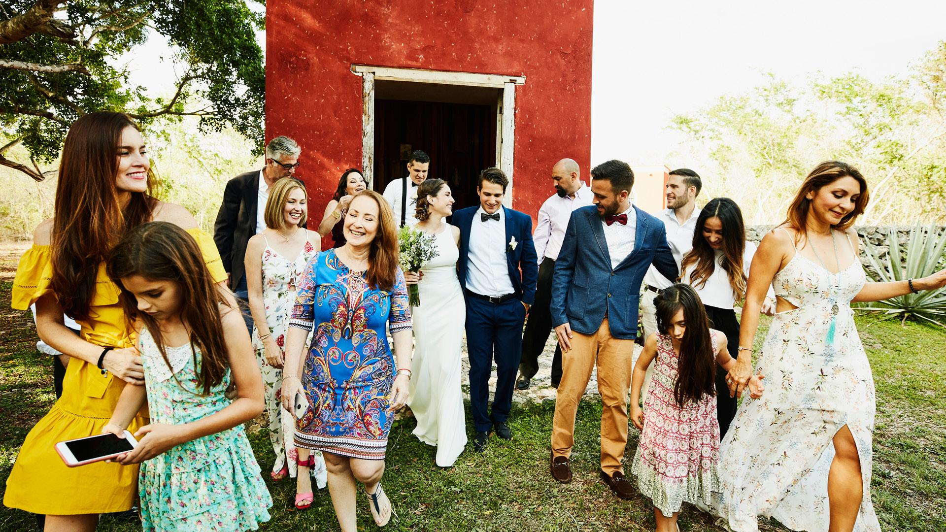 Bride, groom, and guests exiting venue at destination wedding