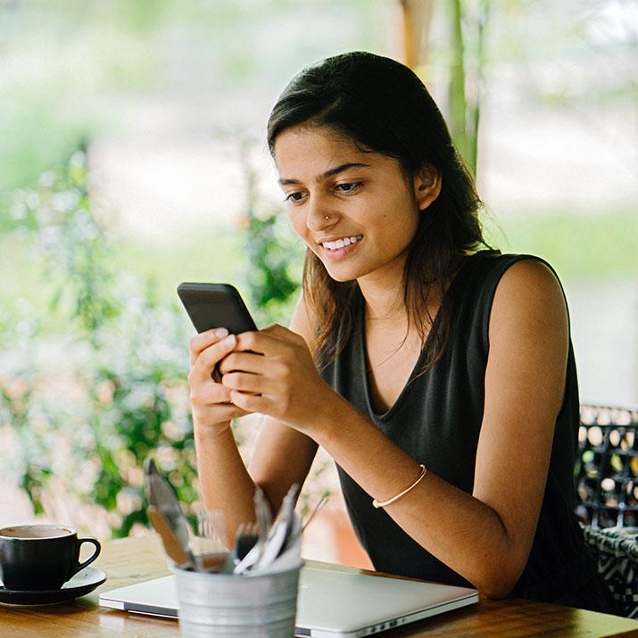 A woman reads on her phone